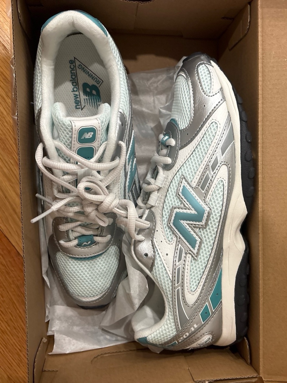 New Balance Women's ice blue and Silver Sneakers
